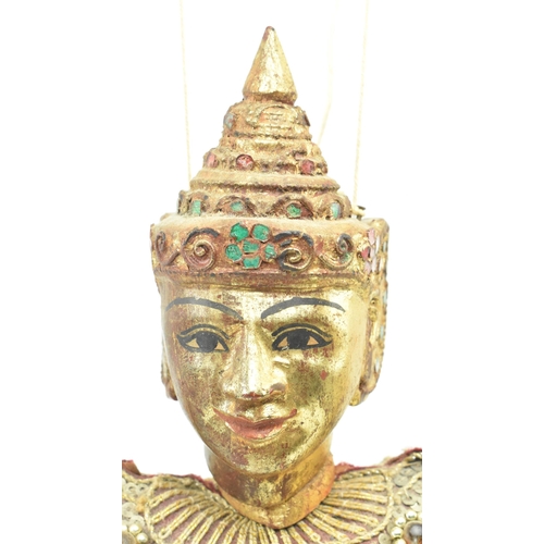 98 - A Burmese Oriental 20th century glass and sequin-adorned gilt wood marionette of possibly a Buddhist... 
