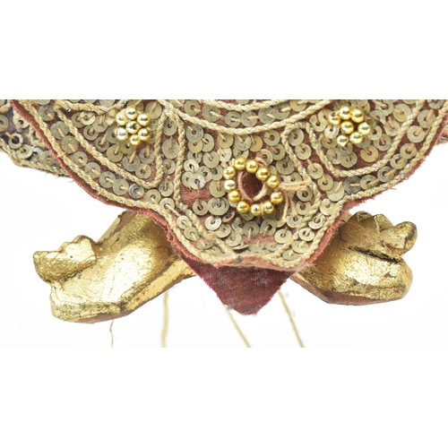 98 - A Burmese Oriental 20th century glass and sequin-adorned gilt wood marionette of possibly a Buddhist... 
