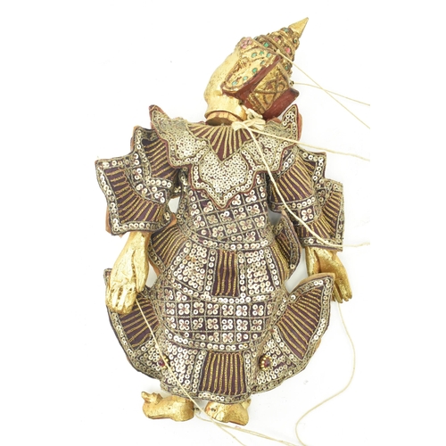 98 - A Burmese Oriental 20th century glass and sequin-adorned gilt wood marionette of possibly a Buddhist... 