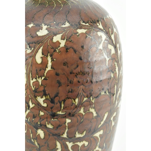 91 - A Yuan dynasty Cizhou brown glazed ceramic meiping vase. The baluster body with carved peonies and f... 