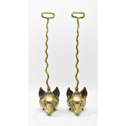 259 - A pair of Victorian 19th century brass fox head door stops. Each with a handle atop over a central b... 