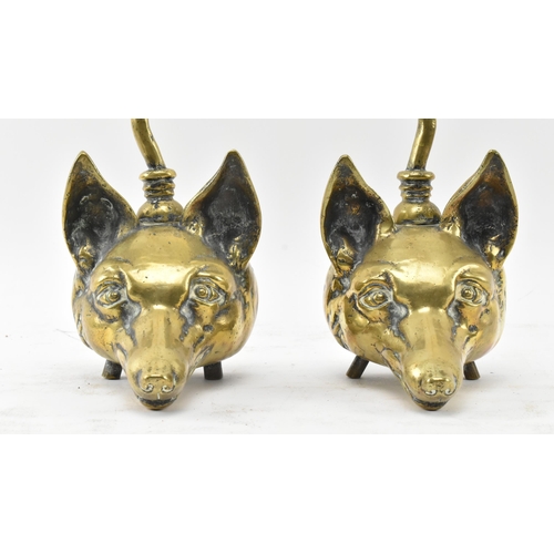 259 - A pair of Victorian 19th century brass fox head door stops. Each with a handle atop over a central b... 