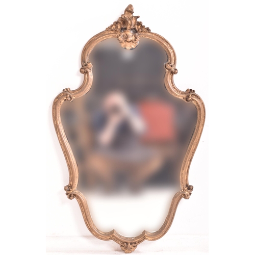 264 - A French inspired Rococo style 19th century giltwood wall hanging mirror. The mirror having an intri... 