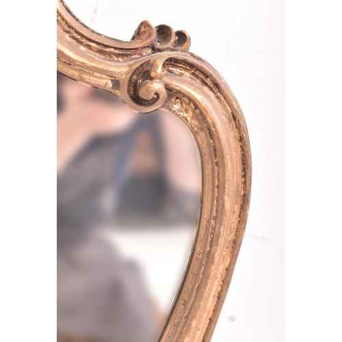 264 - A French inspired Rococo style 19th century giltwood wall hanging mirror. The mirror having an intri... 