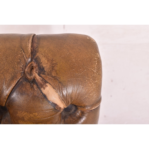 275 - A 19th century leather buttoned gout stool. The stool of mahogany construction with button backed ch... 