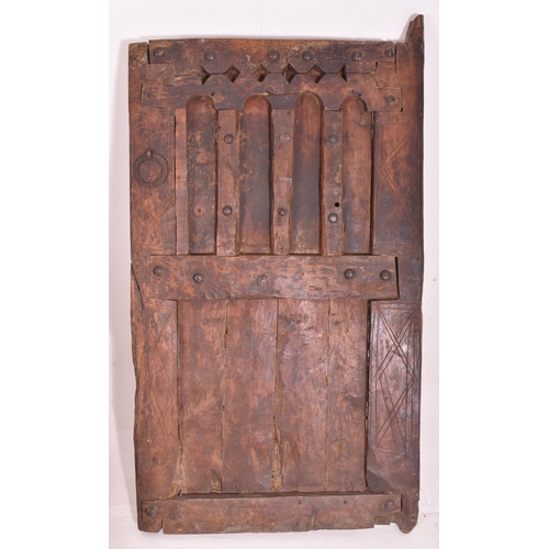 284 - A large Moroccan North African carved wood architectural door. Typical form with carved arched panel... 