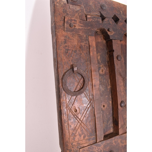 284 - A large Moroccan North African carved wood architectural door. Typical form with carved arched panel... 