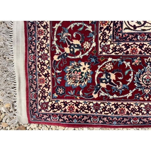 290 - An Iranian Persian Islamic Seirafian Isfahan floor carpet rug. Signed panel to one end translated to... 