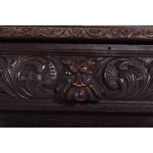 292 - A Victorian 19th century carved oak library bookcase. The cabinet top having two glazed doors flanke... 