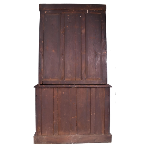 292 - A Victorian 19th century carved oak library bookcase. The cabinet top having two glazed doors flanke... 