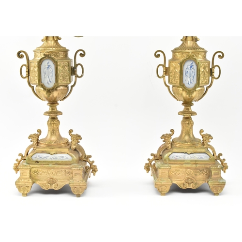 293 - A pair of French Louis XVI style 19th century gilt metal & ceramic desk table candelabras. Each havi... 