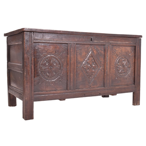 296 - An 17th century carved oak country coffer chest. The coffer having a three panelled hinged top over ... 