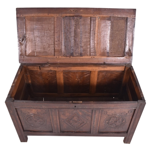 296 - An 17th century carved oak country coffer chest. The coffer having a three panelled hinged top over ... 