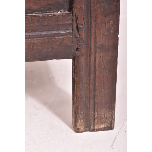 296 - An 17th century carved oak country coffer chest. The coffer having a three panelled hinged top over ... 