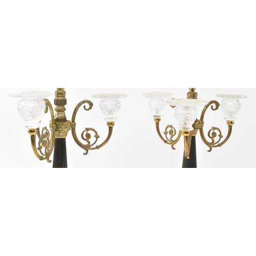 301 - A pair of Regency early 19th century circa 1820s brass & glass table candelabras converted to electr... 