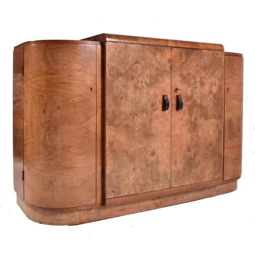 313 - An Art Deco early 20th century circa 1930s figured walnut veneered bow front credenza sideboard. The... 