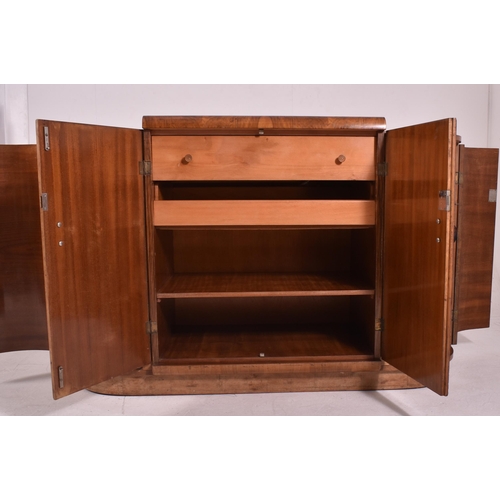 313 - An Art Deco early 20th century circa 1930s figured walnut veneered bow front credenza sideboard. The... 