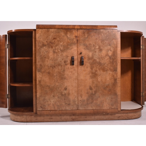 313 - An Art Deco early 20th century circa 1930s figured walnut veneered bow front credenza sideboard. The... 