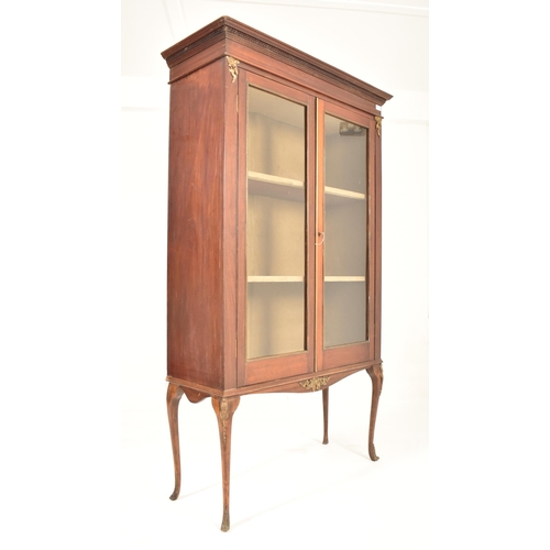 314 - A Victorian 19th century mahogany cabinet on stand. The twin door glazed top housing a series of she... 