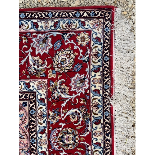 320 - A large Iranian Persian Islamic Seirafian Isfahan signed floor carpet rug. Signed panel to one end t... 