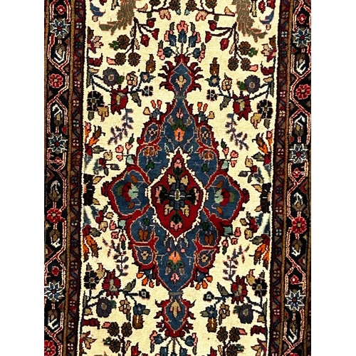 324 - A 20th century North West Persian Islamic Sarouk floor carpet runner rug. The runner rug having cent... 