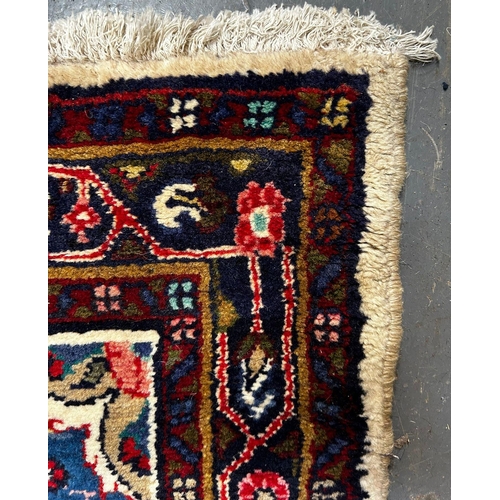 324 - A 20th century North West Persian Islamic Sarouk floor carpet runner rug. The runner rug having cent... 