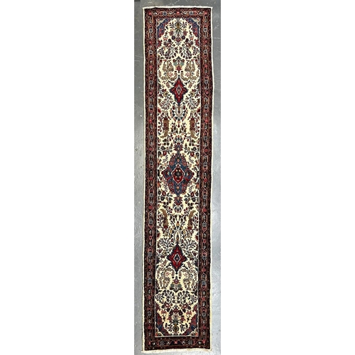 324 - A 20th century North West Persian Islamic Sarouk floor carpet runner rug. The runner rug having cent... 