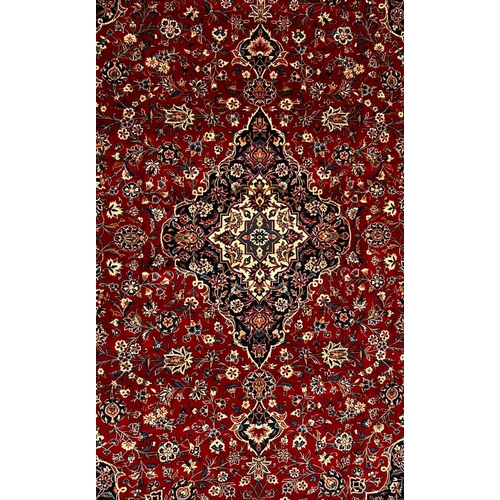 336 - A 20th century Central Persian Islamic Kashan floor carpet rug. The rug having a central floral meda... 