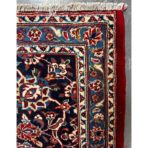 336 - A 20th century Central Persian Islamic Kashan floor carpet rug. The rug having a central floral meda... 