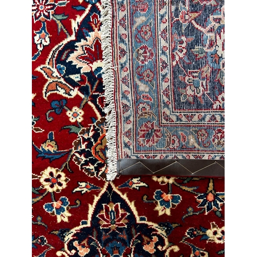 336 - A 20th century Central Persian Islamic Kashan floor carpet rug. The rug having a central floral meda... 