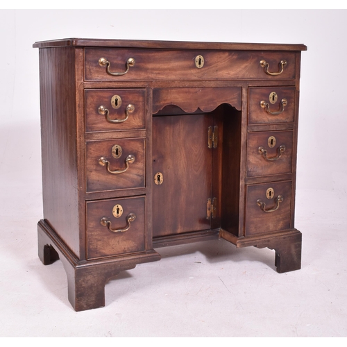 337 - A George III early 19th century mahogany kneehole writing desk. The desk having a chamfered edge rec... 