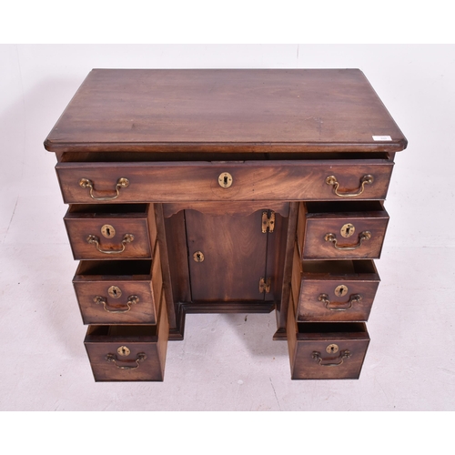 337 - A George III early 19th century mahogany kneehole writing desk. The desk having a chamfered edge rec... 