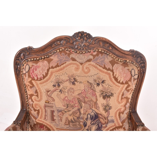 339 - A French continental 19th century oak & petit point fautil upholstered armchair. The chair having a ... 