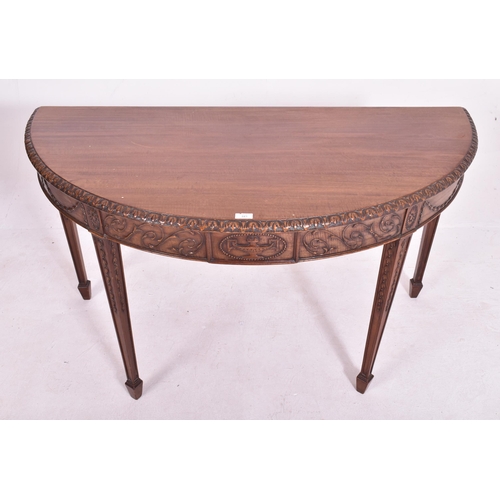 341 - An Adams Revival mahogany demi-lune console hall table. The table having a straight top with carved ... 