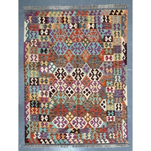 353 - A contemporary Anatolian Turkish Kilim floor carpet rug. The rug having a polychrome series of repea... 