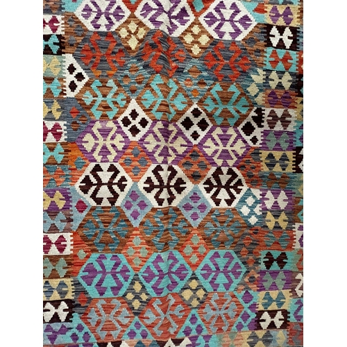 353 - A contemporary Anatolian Turkish Kilim floor carpet rug. The rug having a polychrome series of repea... 