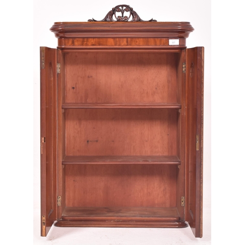 367 - A Victorian inspired walnut wall cupboard cabinet The cabinet having a flared rounded edges pediment... 