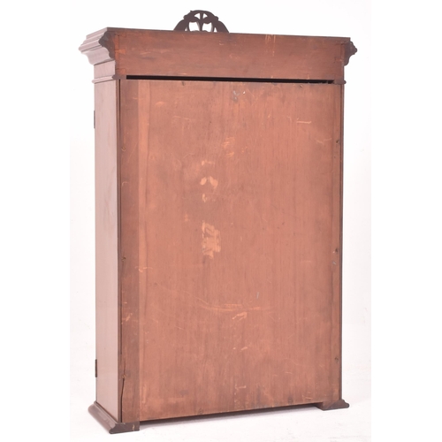 367 - A Victorian inspired walnut wall cupboard cabinet The cabinet having a flared rounded edges pediment... 