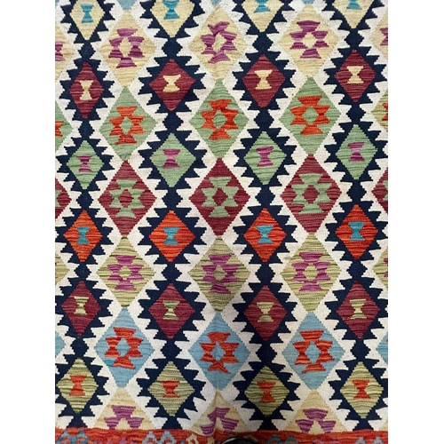 373 - A contemporary Anatolian Turkish Kilim floor carpet rug. The rug having a central panel with series ... 