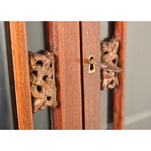 379 - A Chinese Oriental inspired hardwood & gilt painted display cabinet. The cabinet having a astragal g... 