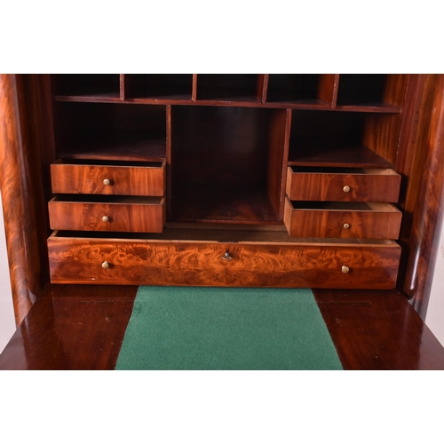 383 - A French Empire 19th century flame mahogany drop down secretaire á abbatant. The secretaire having a... 