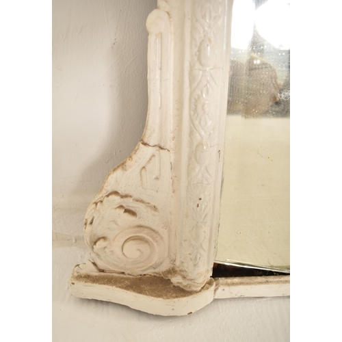 386 - A 19th century Victorian white painted overmantle mirror. The mirror having a shaped frame with foli... 