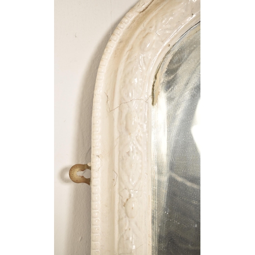 386 - A 19th century Victorian white painted overmantle mirror. The mirror having a shaped frame with foli... 