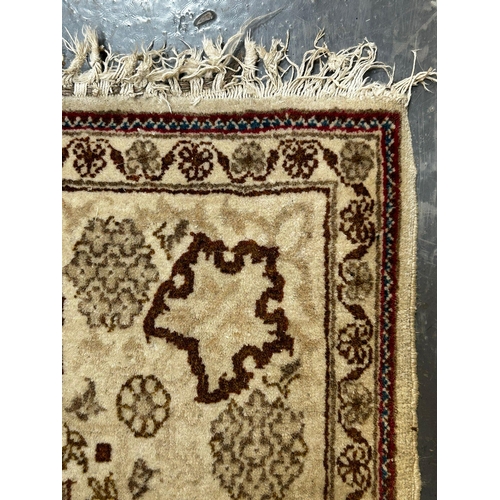 392 - A 20th century Persian Islamic chemically coloured floor carpet rug. The rug in cream & brown colour... 