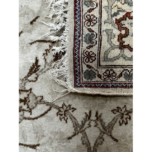 392 - A 20th century Persian Islamic chemically coloured floor carpet rug. The rug in cream & brown colour... 