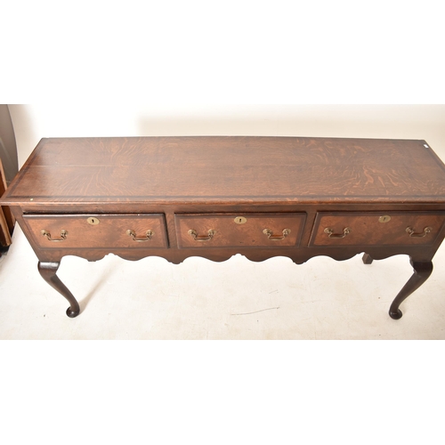 395 - A George III 18th century oak three drawer dresser base sideboard. The base having a straight rectan... 