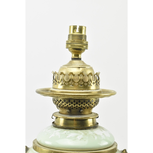 396 - A late 19th century / early 20th century gilt metal mounted pâte sur pâte celadon ceramic desk lamp ... 