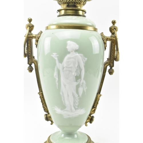 396 - A late 19th century / early 20th century gilt metal mounted pâte sur pâte celadon ceramic desk lamp ... 