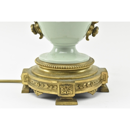 396 - A late 19th century / early 20th century gilt metal mounted pâte sur pâte celadon ceramic desk lamp ... 