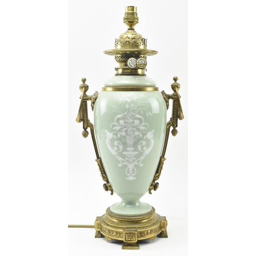 396 - A late 19th century / early 20th century gilt metal mounted pâte sur pâte celadon ceramic desk lamp ... 